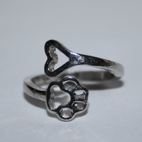 Silver bypass ring with paw and heart